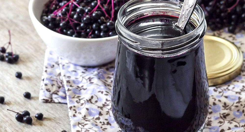 Homemade black elderberry syrup in glass jar