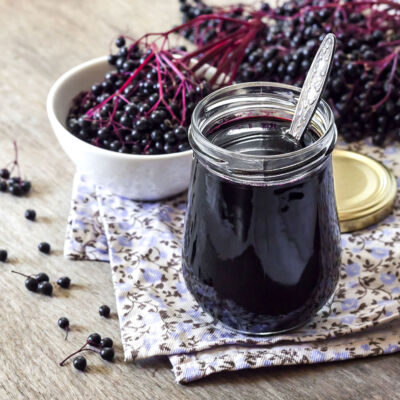 Homemade black elderberry syrup in glass jar
